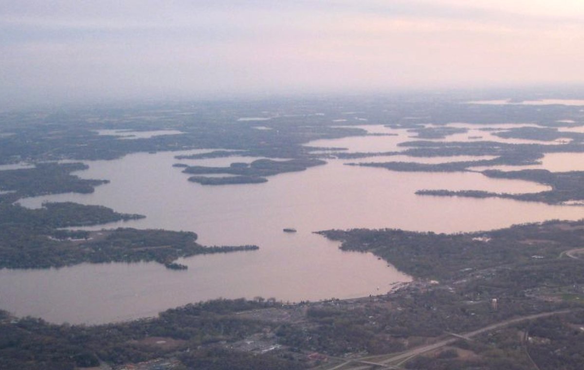 Aerial Minnesota lake landscape used as a place-discovery guide visual.