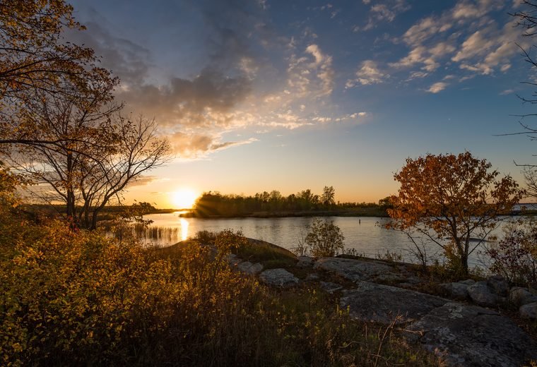 Warm-season sunset on a Minnesota lake used for summer planning.